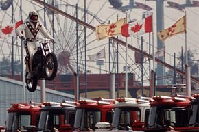 Daredevil motorcyclist Evel Knievel sails over seven Mack trucks during a practice jump in the open-air Canadian national exhibition stadium in Toronto, Ont., on Aug. 20, 1974. See more extreme sports pictures.