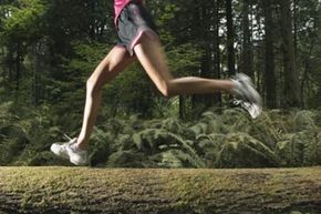 Woman jogging through forest