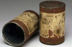 These two tin cans containing food date from the Boer War (1899-1902). Canned food was developed in the 1860s.