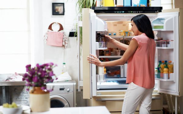 woman looking in fridge