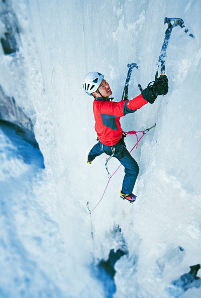 ice climber swinging an ice ax