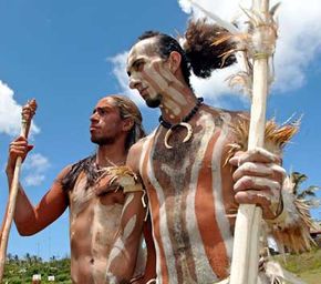 Two men dressed as Rapanui warriors entertain Easter Island tourists in February 2005.