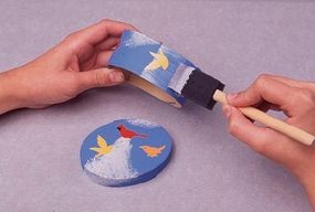 Spread some decoupage finish over the fly away decoupage box by using a sponge brush.
