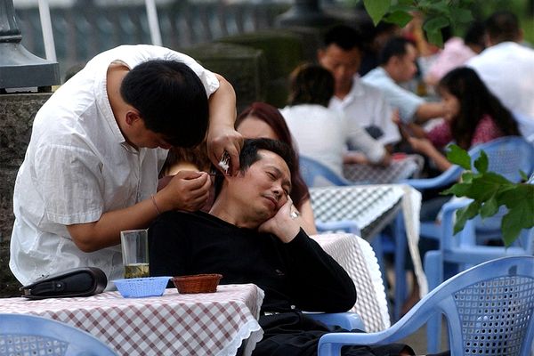 Chinese man getting earwax removed