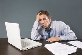 man sweating at his desk