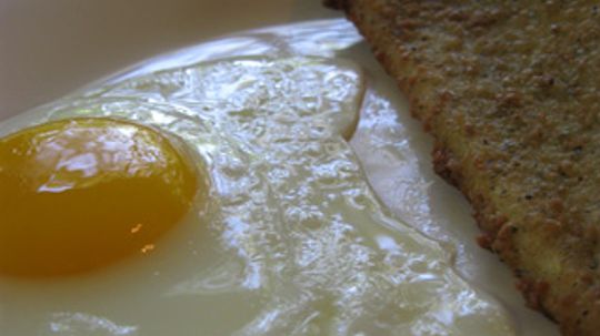 Why do eggs turn hard when you boil them?