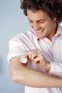 Man applying nicotine patch