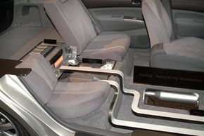 This cutaway car shows the location of the battery pack in a 2004 Toyota Prius, right behind the rear seat.