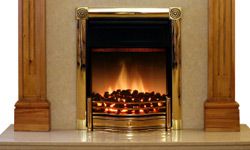 Typical pine fire surround with electric fire on marble hearth.