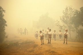 In 1997, Indonesian children walked through smoke as wildfires brought on by El Nino raged across the country.