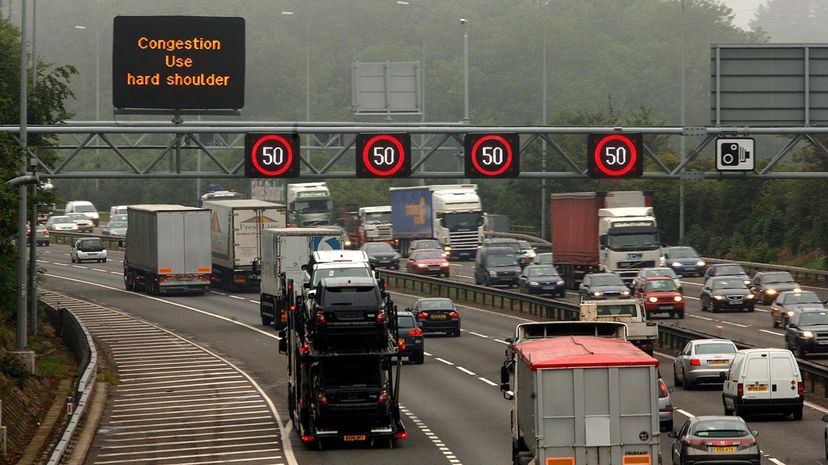A sign instructs motorists on a British highway to drive on the road shoulder when traffic is congested. Some places in the U.S. also allow this practice. David Jones - PA Images/PA Images via Getty Images