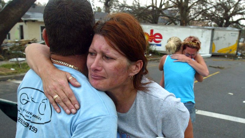 Petra Button (C) hugs her friend, Lewis Grant Martin, after seeing him for the first time since Hurricane Katrina, Sept. 1, 2005 in Gulfport, Mississippi.
 Ross Taylor/Getty Images