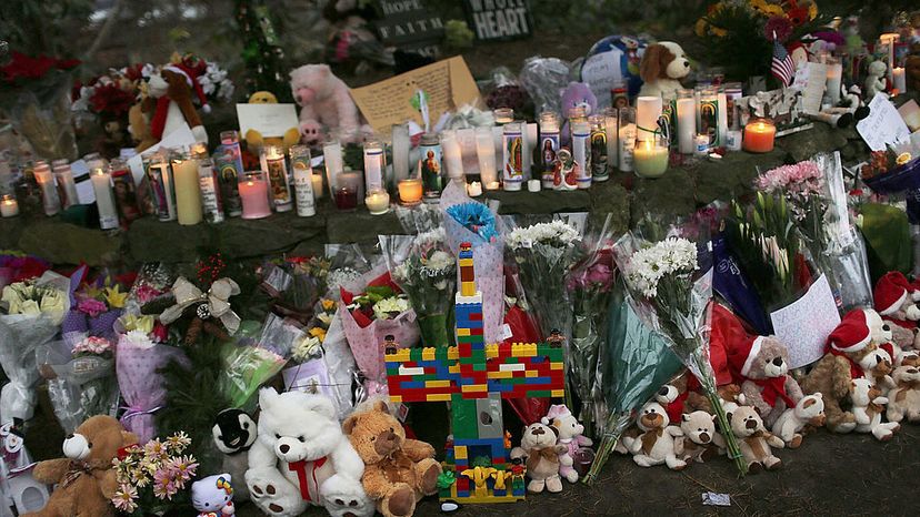 Teddy bears, flowers and candles are left at a memorial down the street from the Sandy Hook School in Newtown, Connecticut, Dec. 16, 2012. The town of 27,000 received 65,000 teddy bears after the school shooting that left 20 children dead.
 Spencer Platt/Getty Images