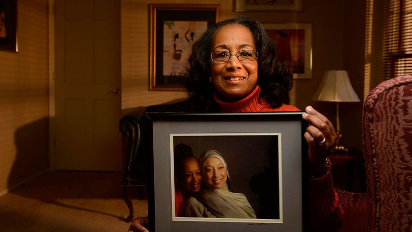 Colorado author Patricia Raybon shows photograph of her and her daughter Alana Raybon who lives in Nashville, Tennessee, in 2015. The two wrote a book, 'Undivided,' about how they healed their relationship after Alana converted to Islam from her Christian upbringing.
 Cyrus McCrimmon/The Denver Post via Getty Images