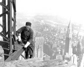 A structural worker on a steel girder during the construction of the Empire State Building in 1930