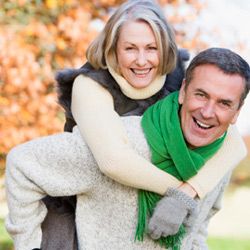 man gives woman piggyback ride