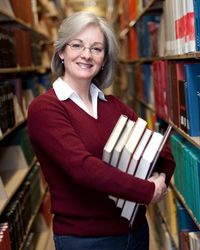 woman with books in library