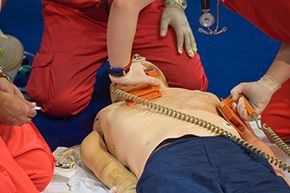 EMR training includes learning the basics of emergency care such as performing CPR and using a defibrillator.
