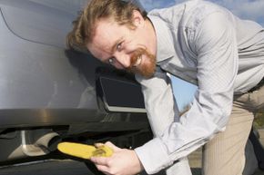 Guy sticking banana in tailpipe