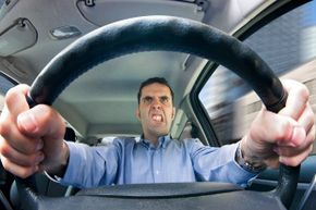 guy gripping car steering wheel