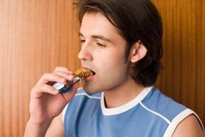 man eating energy bar