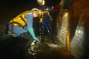 Thames Water Utilities sewer workers inspect a sewer beneath the streets of London.