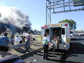 Medical personnel place an injured person into an ambulance 