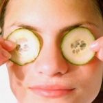 woman with cucumbers on her eyes