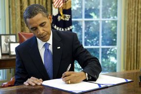 President Barack Obama signs an extension of unemployment benefits in July 2010.