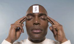 Man with ESP test card on his forehead