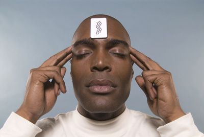 Man with ESP test card on his forehead