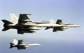 F/A-18s bank while in formation. See more military jets pictures.
