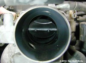 A partially open throttle valve for a car.