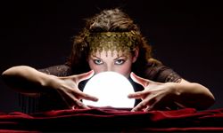 woman looks into crystal ball