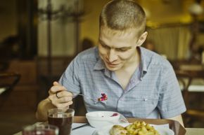 A man eats at a restaurant.