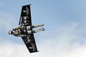 Swiss professional pilot Yves Rossy, better known as FusionMan, the world's first man to fly with fitted jet fuel powered wings strapped to his back, flies during his first official demonstration on May 14, 2008, over Bex, Switzerland.