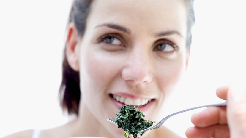 woman eating spinach
