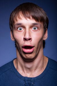 Portrait of young man with his jaw dropped open.