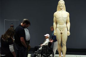 Visitors look at the possibly fake statue at the Getty Villa Museum in Malibu, Calif. on April 18, 2011.