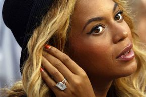 Beyonce flashes her engagement ring while watching the 2011 U.S. Open tennis championships. Reportedly the 18-carat diamond ring cost $5 million. Was that two months of Jay-Z's salary?