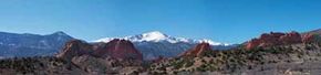 The snow-capped majesty of Pikes Peak looms over the red rock formations ofGarden of Gods in Colorado Springs.