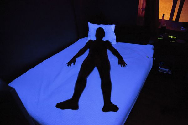 Shadow person lying in bed