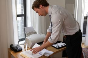 A man uses a fax machine