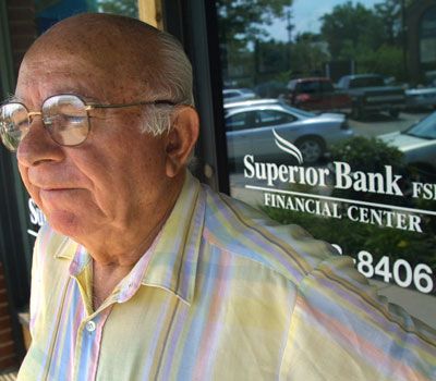 A customer stands outside a branch of Superior Bank 