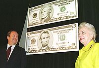 Treasury Secretary Lawrence H. Summers and Treasurer Mary Ellen Withrow unveil the new five and 10 dollar bills in November 1999.