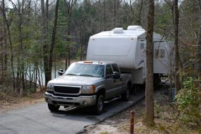 Pickup truck with a fifth wheel set-up towing a trailer.