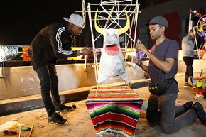Darius (left) and Cameron (right) of &quot;The Amazing Race&quot; must build the frame of a 'torito,' a paper mache bull rigged with fireworks, hoist it to the top of a 15-foot pole and light it. Competition shows are not usually rigged because of strict federal laws.