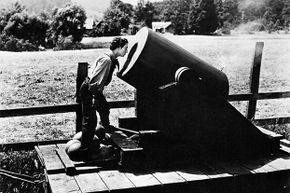 Buster Keaton peers inside what appears to be a cannon in 'The General.'