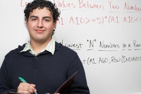 Student standing in front of whiteboard.