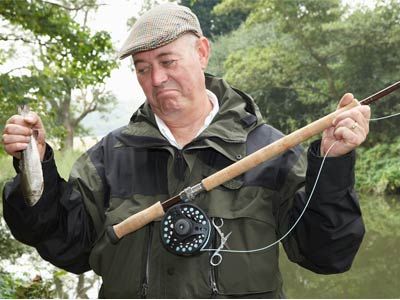 Men fishing outdoors with rods.